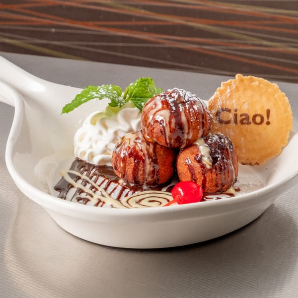 Fried dough balls with chocolate, whipped cream, mint, cherry, and a "Ciao!" cookie.